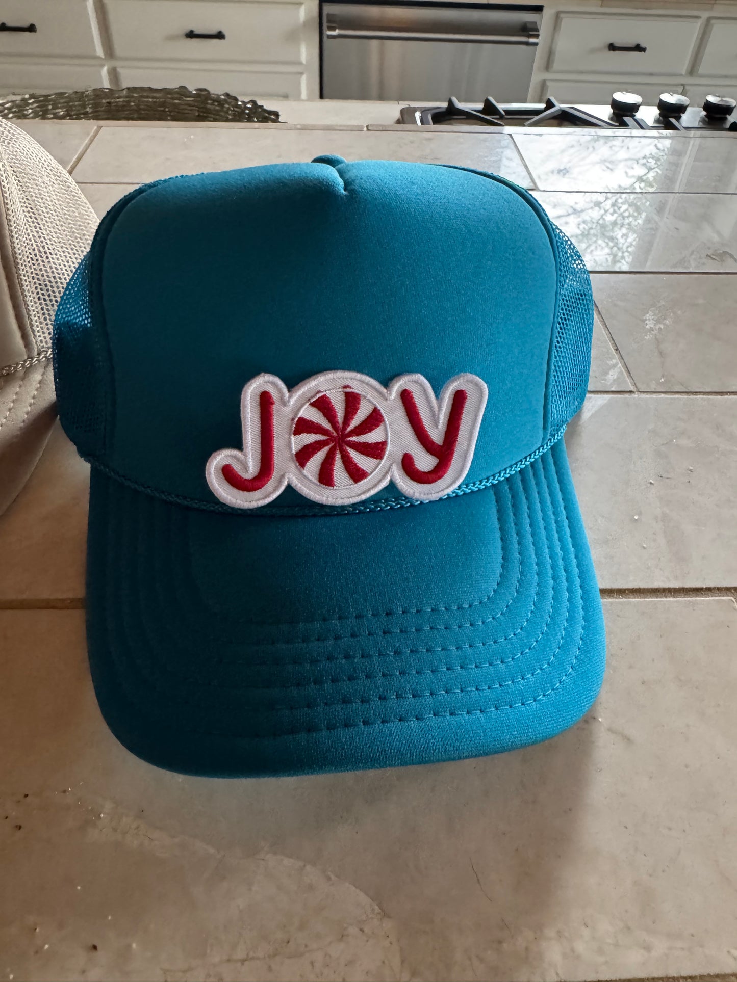 Turquoise hat with red joy patch